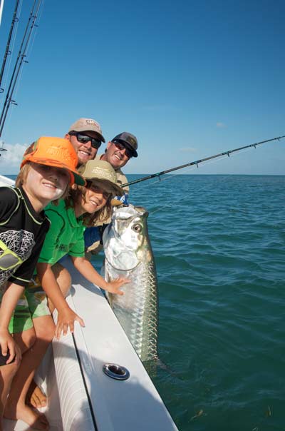 Kids pose next to their dad's tarpon he caught in Key West